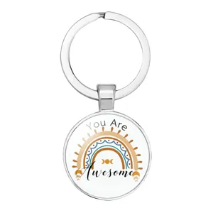Detailed view of silver round keychain featuring a bohemian rainbow and You Are Awesome text