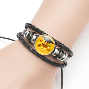 Macro view of multi-layer black braided leather bracelet with graduation emoji cabochon