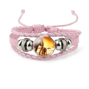 Detailed view of pink multilayer woven bracelet featuring elephant family glass charm