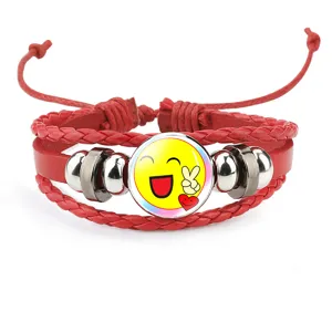 Macro detail of red leather bracelet with happy yellow smiley face emoji cabochon