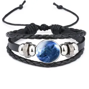 Macro shot of a multi-layer black leather bracelet featuring a blue wolf cabochon