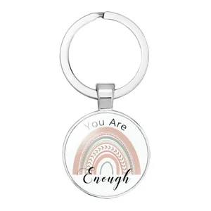 Close-up of a boho rainbow keychain with 'You Are Enough' inspirational quote on white