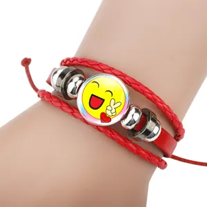 Detail shot of red leather braided bracelet featuring a yellow smiling face emoji charm