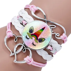 Detailed view of the rainbow unicorn glass gem and silver heart charms on the bracelet