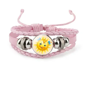 Detailed close-up of pink multi-layer leather bracelet featuring a smiling cartoon sun charm