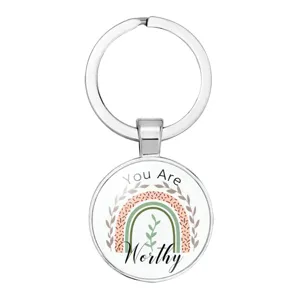Close-up of circular keychain with boho rainbow and 'You Are Worthy' text