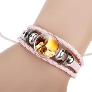 Detailed view of pink braided leather bracelet with elephant sunset cabochon