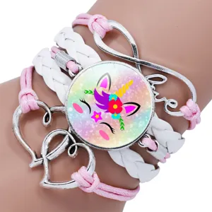 Detailed view of a multi-layer unicorn glass cabochon bracelet with heart charms.