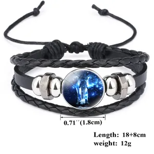 Close-up of black braided leather bracelet featuring a starry blue elephant glass charm