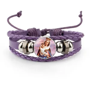 Macro view of purple cowhide leather bracelet with religious Madonna and Child charm