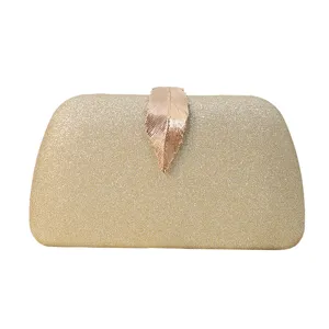 Elegant gold glitter evening clutch bag with distinctive metallic leaf clasp closure