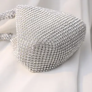 Handmade silver heart-shaped evening clutch bag covered in sparkling luxury rhinestones