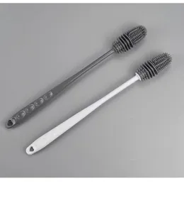 Close-up of grey and white long-handle silicone bottle brushes for deep cleaning