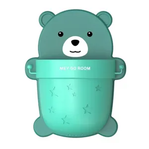 Close-up of teal bear-shaped wall-mounted storage cup with star patterns.