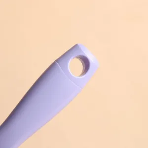 Close-up detail showing the ergonomic handle and hanging hole of a purple vent massage hairbrush