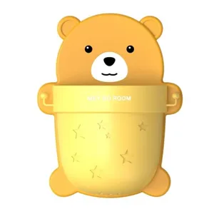 Detail view of yellow bear wall-mounted storage cup with star patterns and hooks.