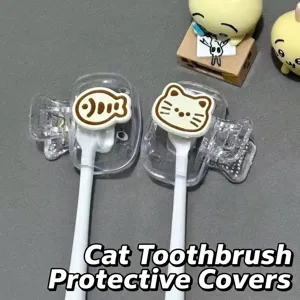 Detail of cute cat and fish cartoon plastic toothbrush protection clips on handles