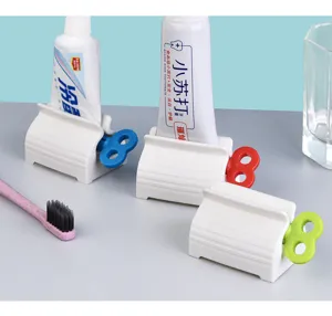 Detailed view of white rolling toothpaste squeezer dispensers with colorful knobs