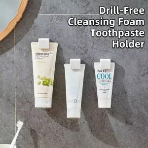 Modern wall-mounted white plastic clips for organizing toothpaste and facial cleanser tubes