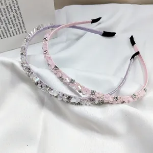 Close-up of elegant handmade pink and purple crystal beaded headbands with rhinestones