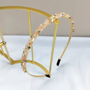 Close-up of handmade peach crystal and rhinestone slim headband for elegant styling