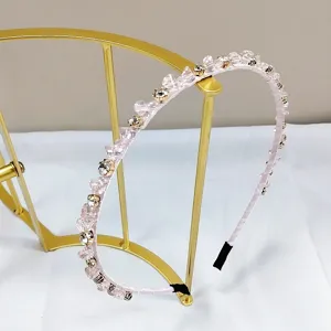 Detail view of a handmade pink crystal rhinestone thin headband for elegant hair styling