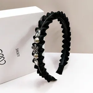 Elegant black pleated headband featuring crystal flower and pearl embellishments