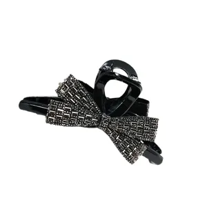 Elegant Korean-style black hair claw clip featuring a rhinestone-encrusted bow detail