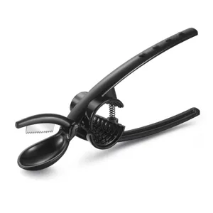 Black ergonomic chestnut opener tool with stainless steel blade on white background