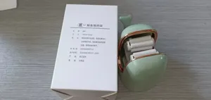 Creative whale-shaped wall-mounted mop holder next to its white product information box