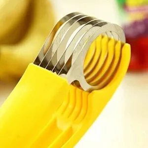 Κοντινό πλάνο λεπίδων από ανοξείδωτο χάλυβα σε κίτρινο κόφτη μπανάνας και φρούτων