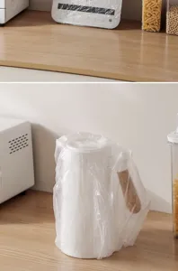 Disposable appliance dust cover protecting an electric kettle in a kitchen setting
