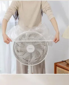 Detail view showing a transparent disposable dust cover applied to a white household fan