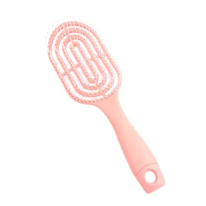 Pink vented hair brush for scalp massage and volumizing hair styling with a hollow design.