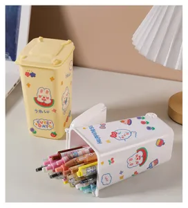 Close-up detail of cute cartoon mini desktop trash can used as a pen holder on desk