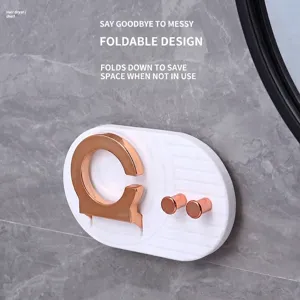 Foldable wall-mounted hairdryer holder with hooks and rose gold accents in a bathroom setting