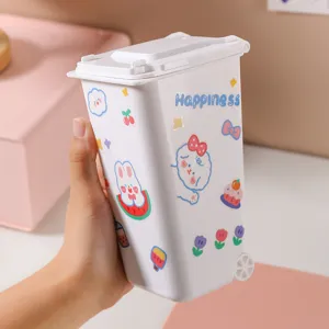 Mini white desktop trash can with cute cartoon stickers and flipping lid for home office