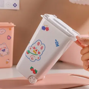 White mini desktop trash can with cute rabbit stickers and flip lid for office desk