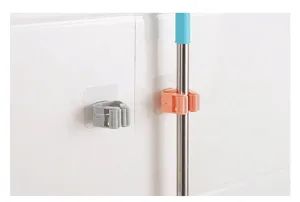 Detail view showing wall-mounted adhesive mop holders in grey and orange colors