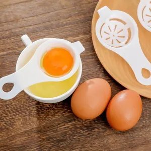 White plastic egg white separator tool for kitchen baking with egg yolk separation