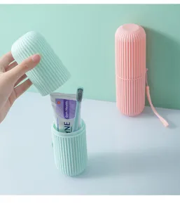 Portable travel wash cup with striped texture showing internal storage for toothbrush.