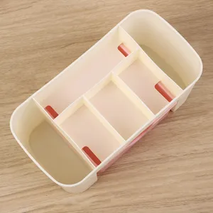Organizzatore cosmetico in plastica a più scomparti per scrivania in crema e rosa.