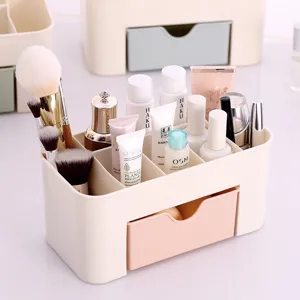 Dettaglio dell'organizer per cosmetici crema con scomparti e cassetto rosa pieno di trucco