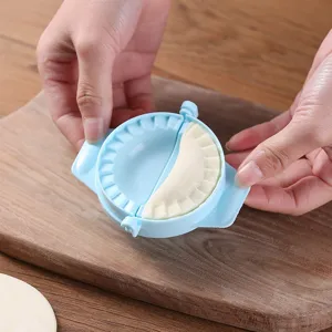 Blue plastic dumpling maker mold for easy crescent-shaped dumplings at home