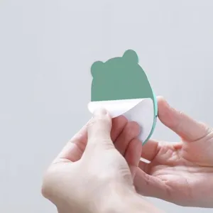 Cartoon bear-shaped adhesive plug hook with easy-peel backing for damage-free wall mounting