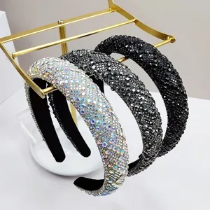 Detailed view of three luxury rhinestone headbands in iridescent, grey, and black.