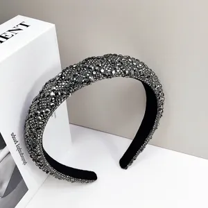 Detailed close-up of a luxury grey rhinestone padded headband with velvet lining