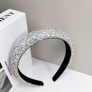 Close-up macro view of a luxury wide headband fully encrusted with sparkling silver rhinestones