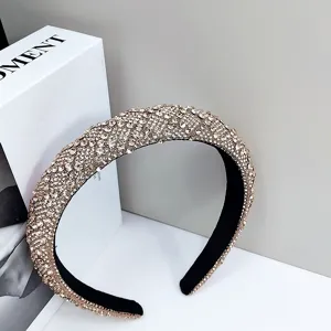 Close-up of a luxurious padded headband fully encrusted with champagne rhinestones