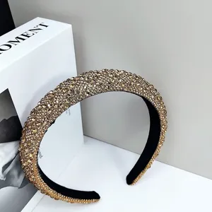 Macro detail of luxury sparkling gold rhinestone padded headband for formal evening wear